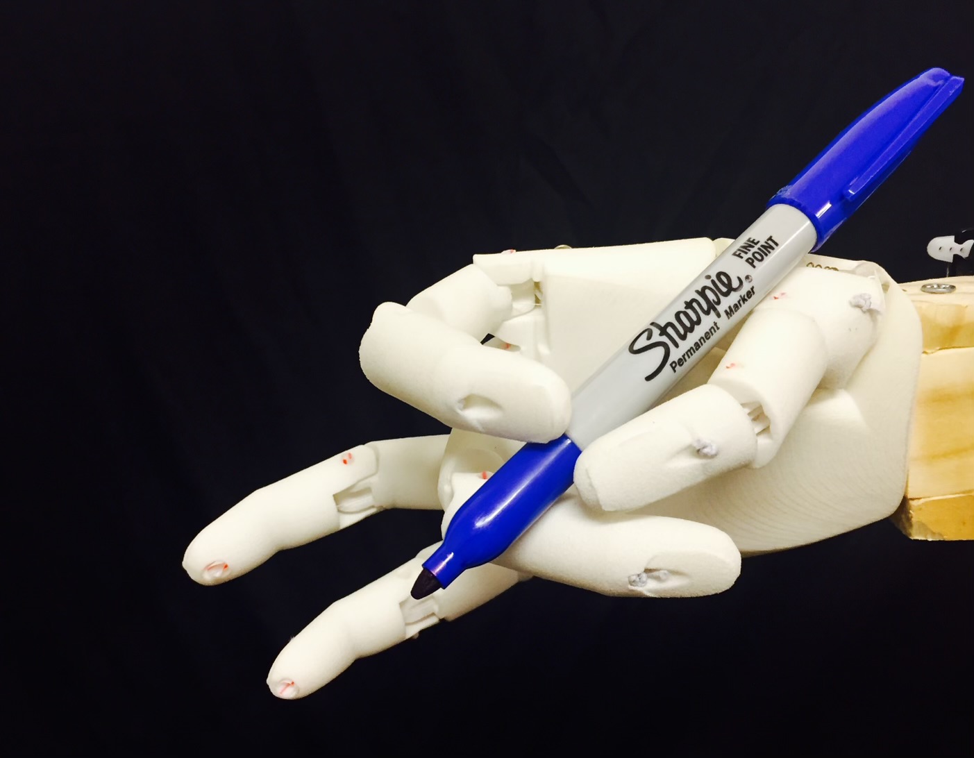 Bionic hand holding a pen